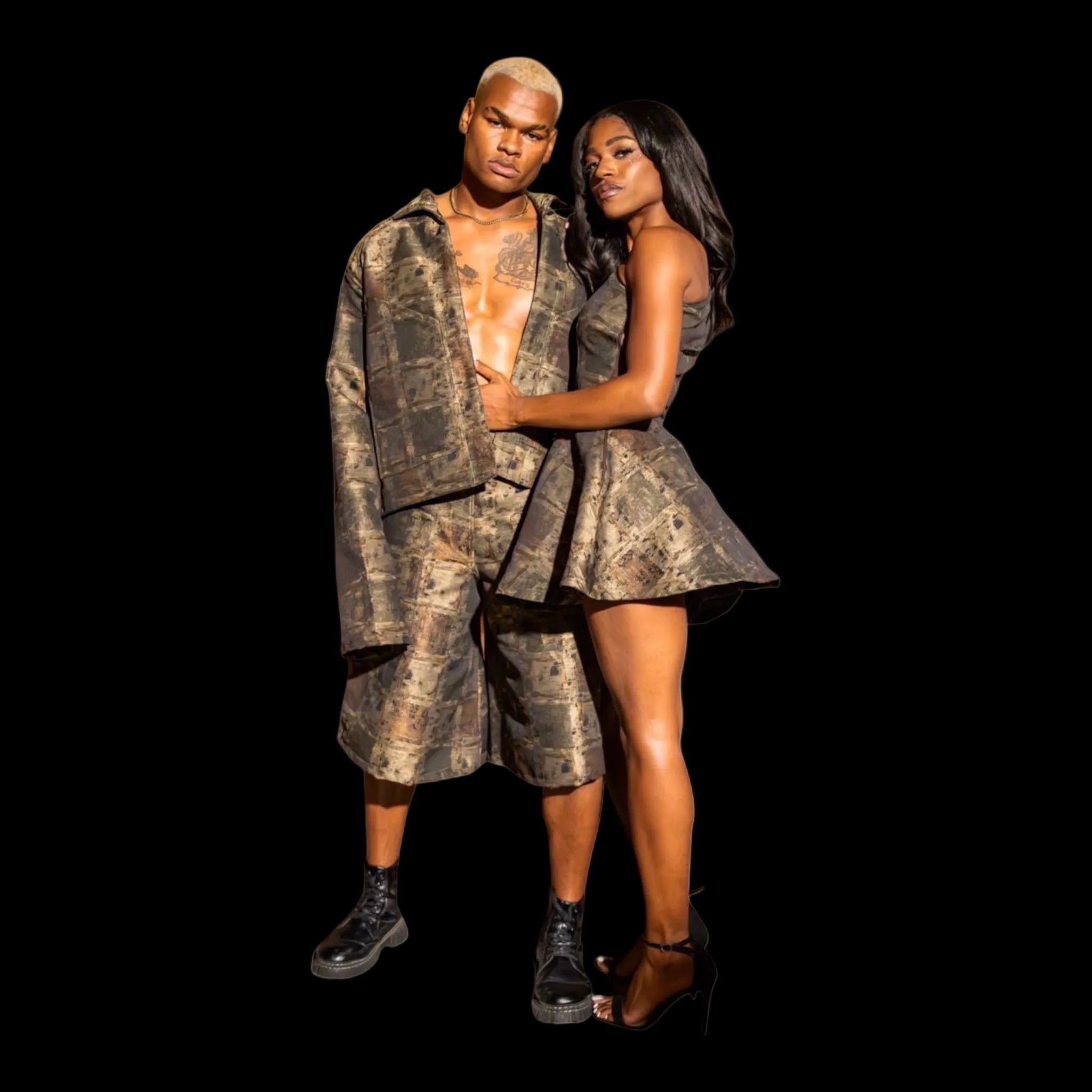 Two people wearing matching camouflage outfits on a black background